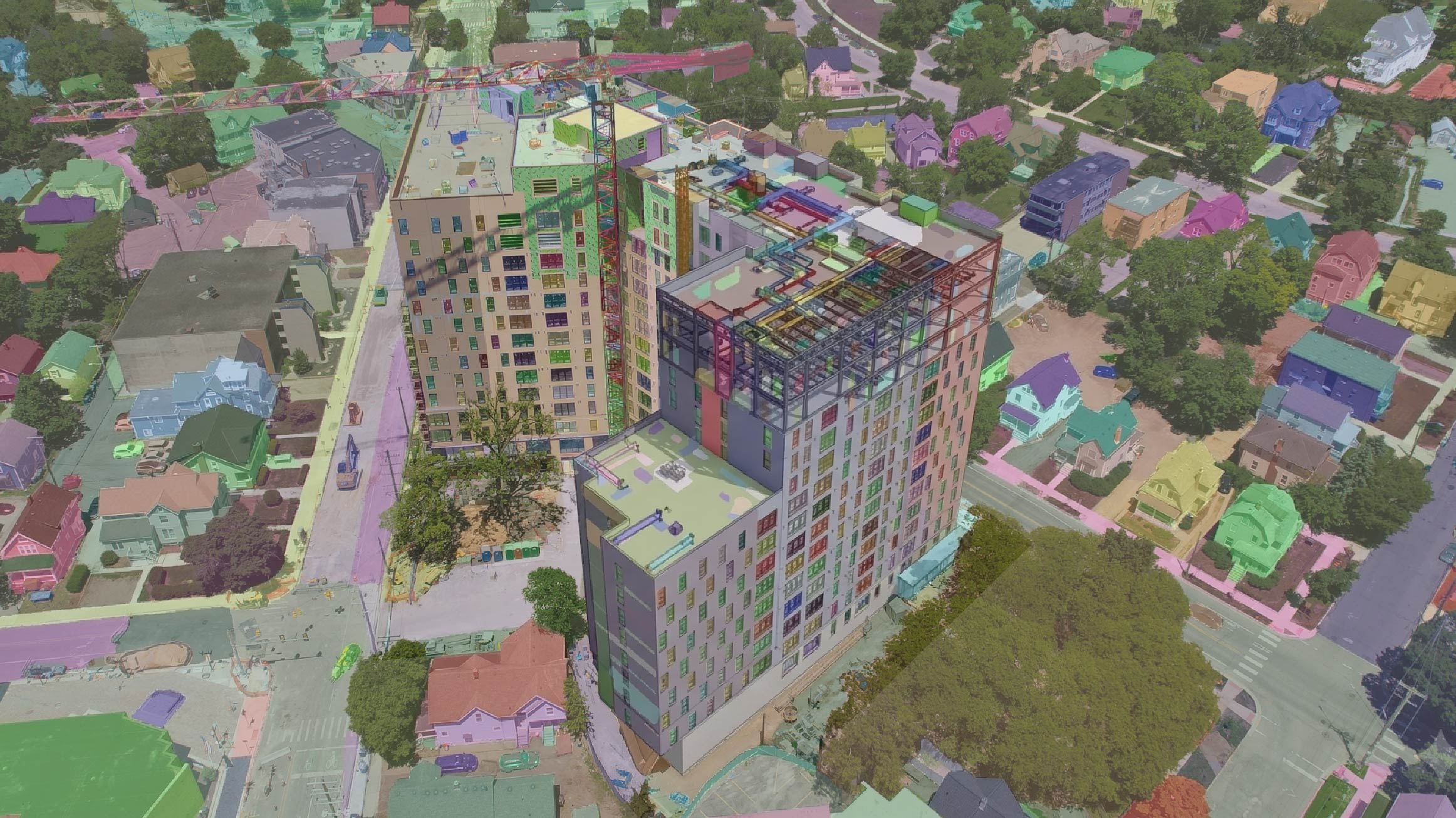 Digital twin visualization overlaying a building model on a 3D site scan